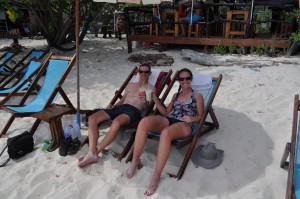 Enjoying fruit shakes on the beach while trying (in vain) to reduce our cycling tan lines!