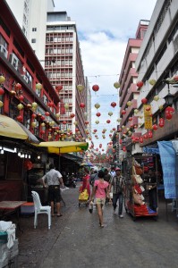 The bustling street market with festive paper lanterns overhead.