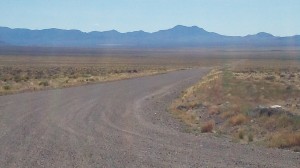 Yess, follow this non-descript dirt road a mere 10 miles to the other side of those mountains, and there you find the Area 51 Boundary. We decided that for us--on bicycles--this view from the highway was enough.